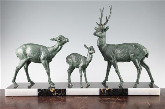 A French Art Deco patinated bronze group modelled as a family of three deer, 27.5in.